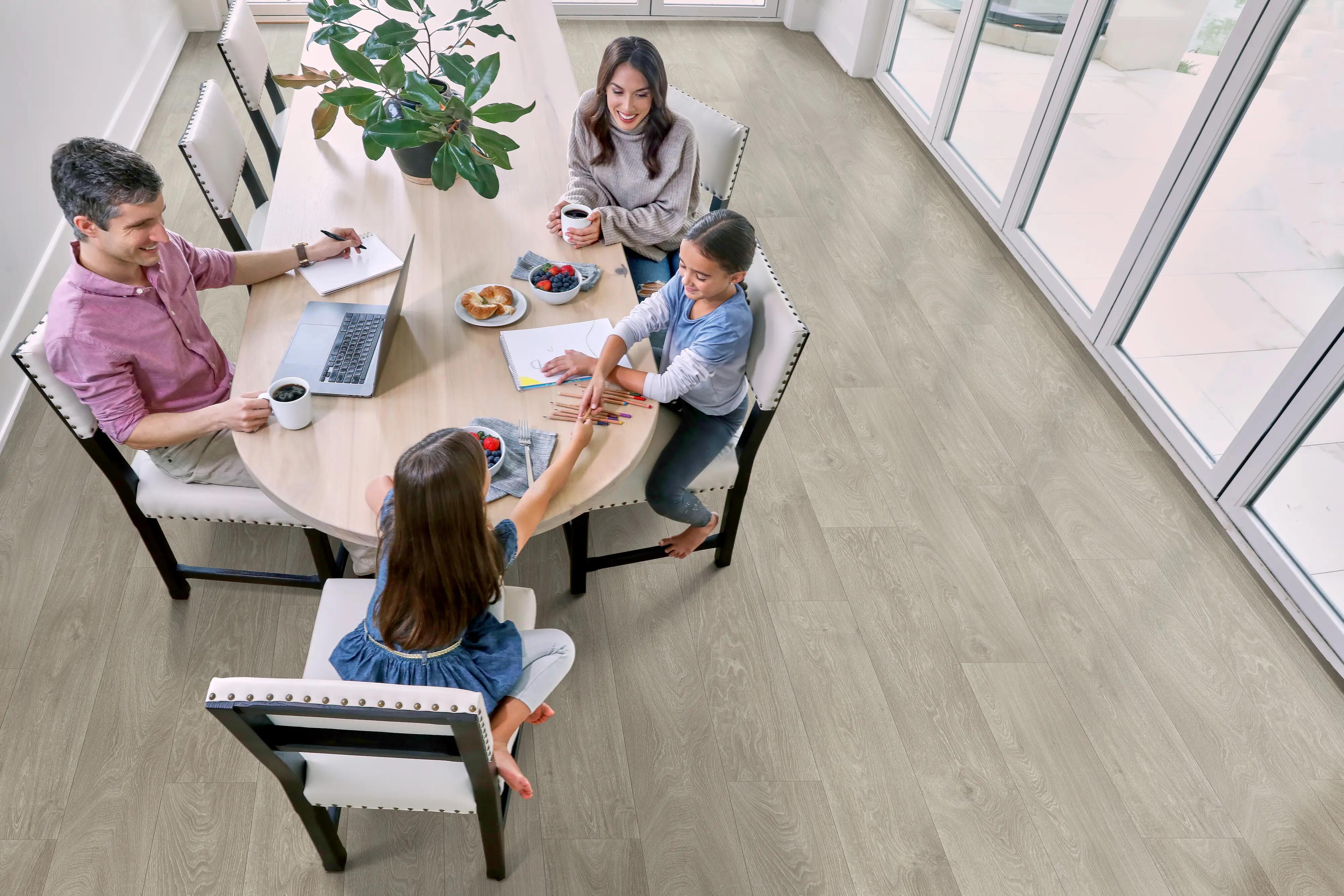 A family in a dining room with Beauflor US luxury vinyl roll flooring in batiste 169l