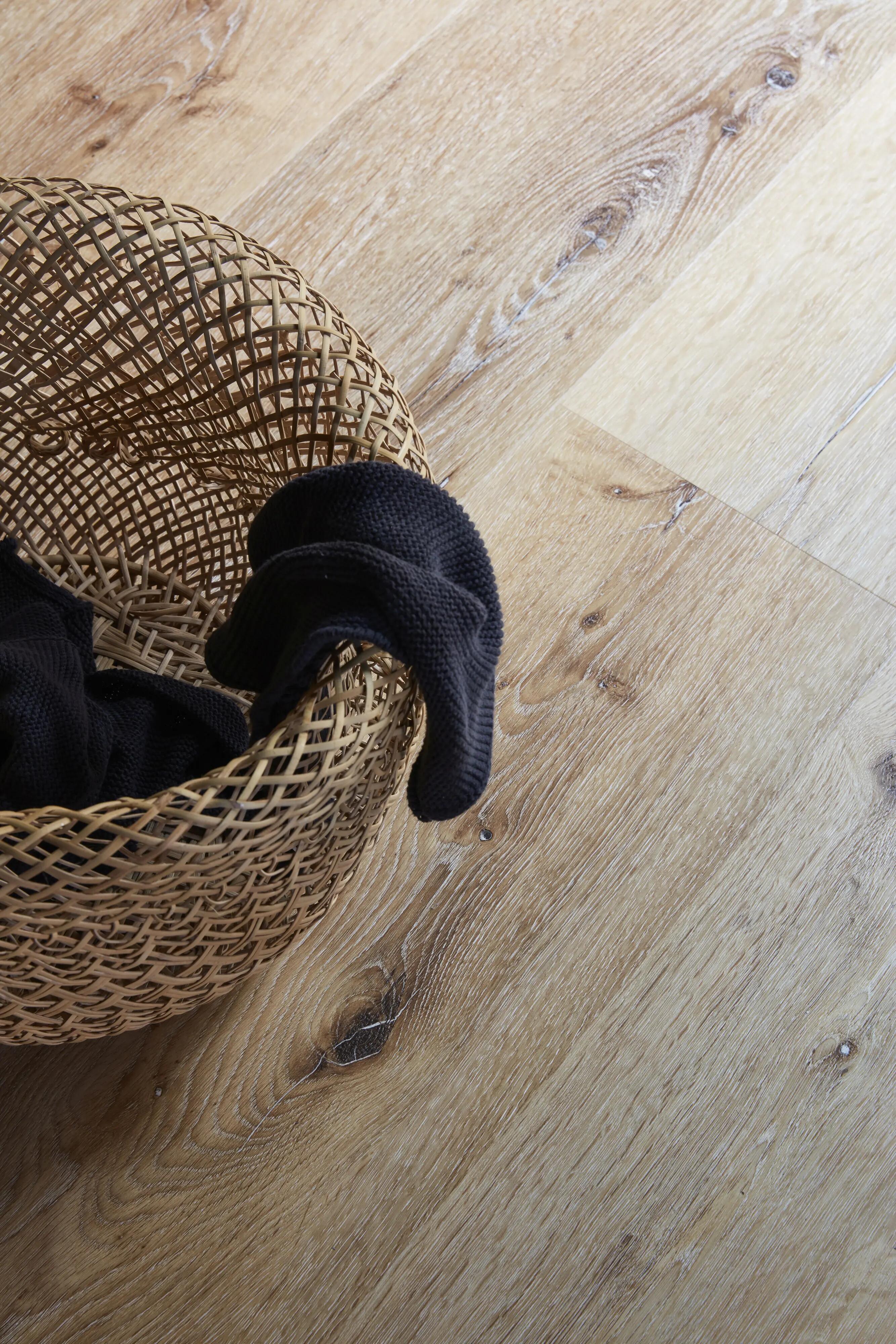 BerryAlloc Country Caramel medium brown luxury vinyl tile flooring in a living room
