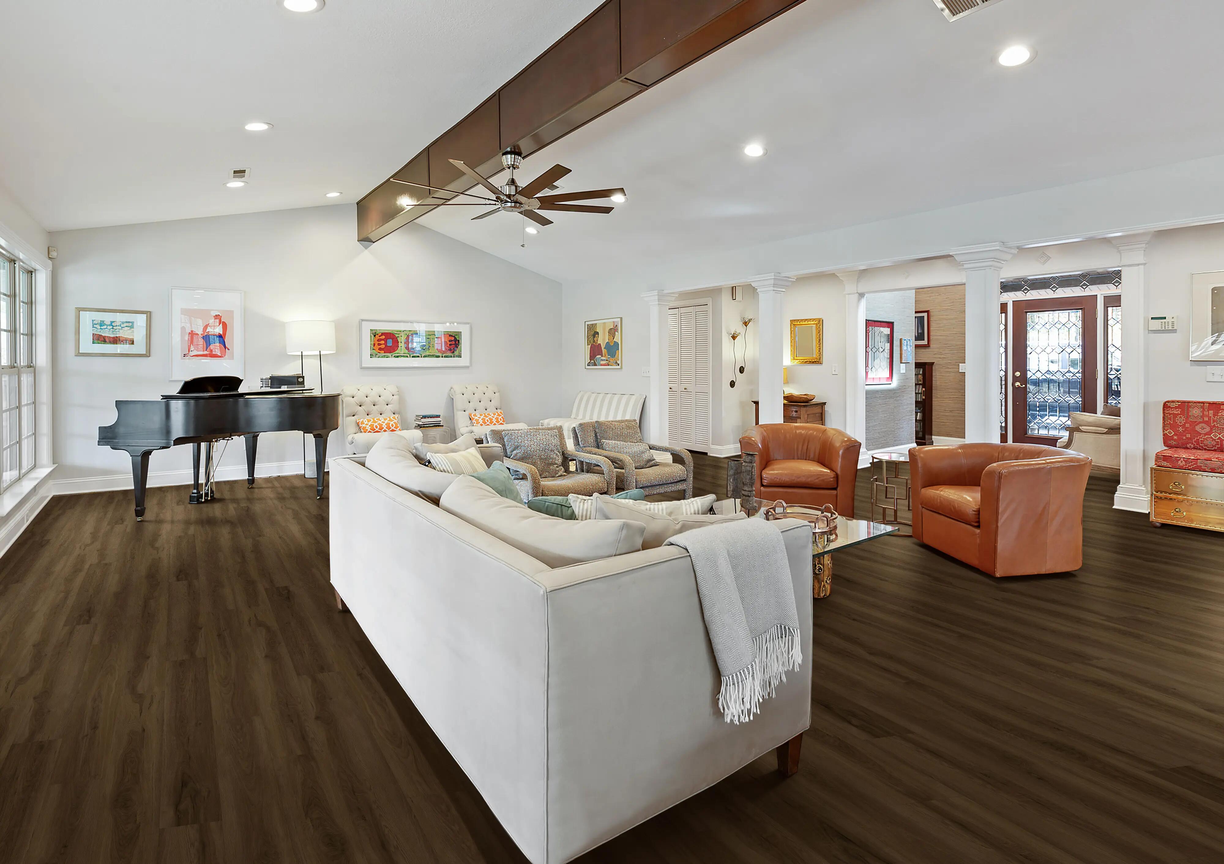 Living with low vaulted ceiling, central exposed beam and piano in the background